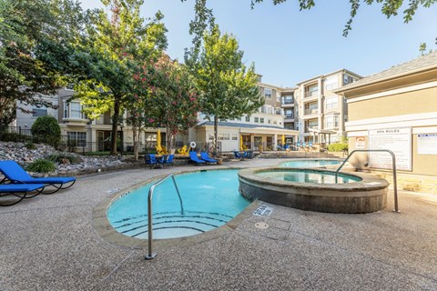 Our community swimming pool with stairway into pool at Encore at Buckingham apartments in Richardson, TX